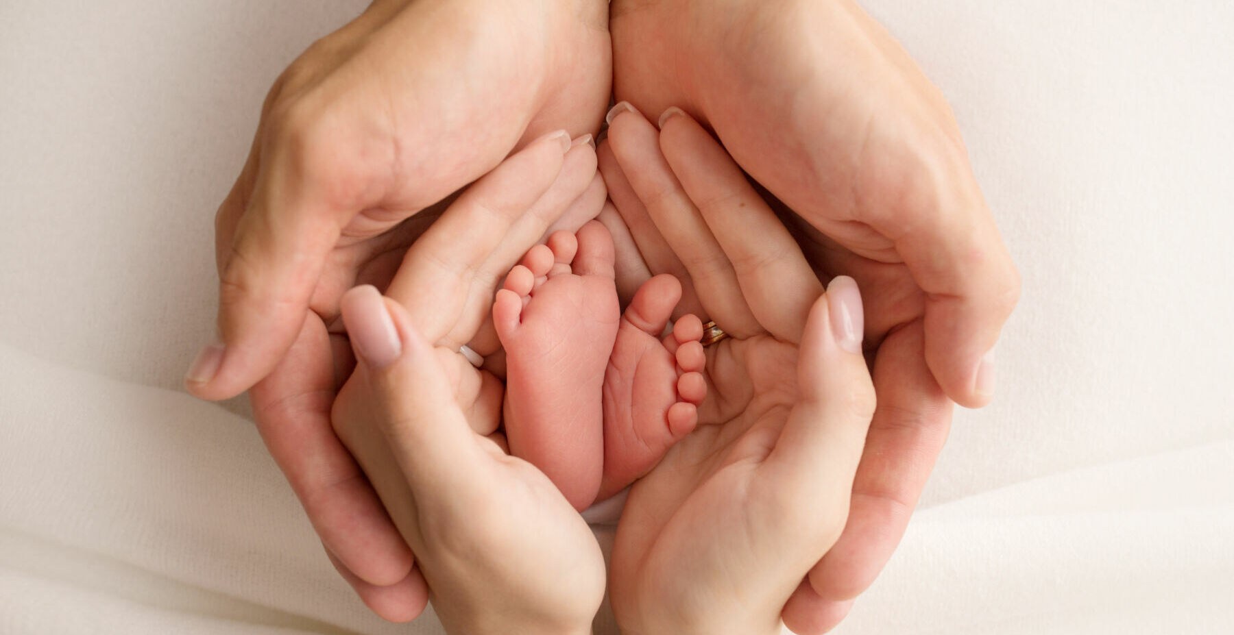 the legs of the child in the arms of our mother and father. feet of a newborn baby. little baby legs.